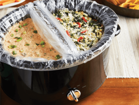 Slow cooker divided in half and lined with slow cooker liners