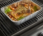 Roasted chicken and vegetables sitting in a pan on the grill