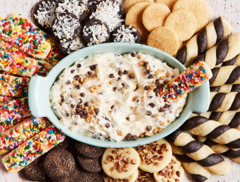 An assortment of cookies surrounding a dip