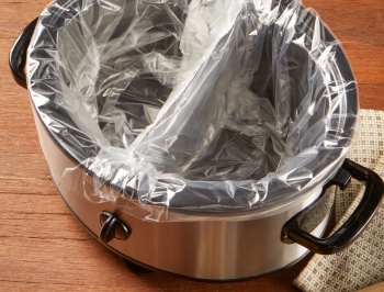slow cooker divided in half and each side lined with a slow cooker liner