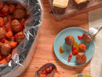 Sweet and sour meatballs in a slow cooker lined with a Reynolds slow cooker liner