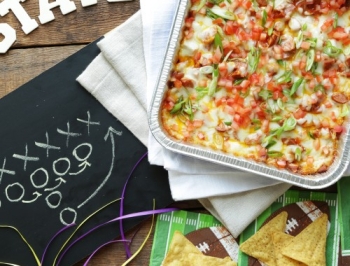 Layered taco dip in a disposable aluminum pan