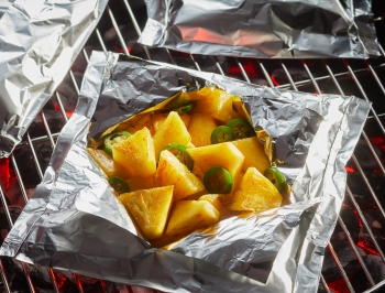 pineapple and jalapenos in a foil packet on the grill