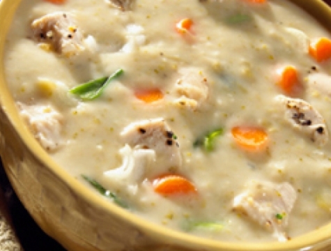 Creamy chicken soup in a yellow ceramic bowl