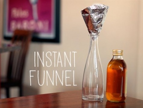 foil funnel sitting atop a glass bottle