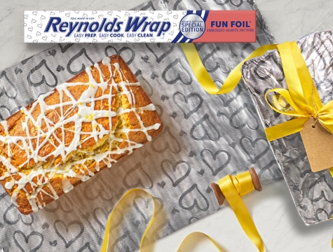 lemon poppyseed bread sitting on a sheet of Reynolds Wrap Fun Foil with embossed heart pattern