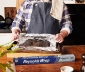 Person Unwrapping Cooked Brisket In Foil