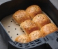Cooked rolls sitting on an air fryer liner in an air fryer