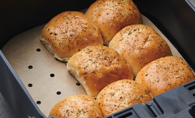 Cooked rolls sitting on an air fryer liner in an air fryer
