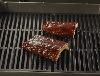 rack of ribs sitting on grill grates