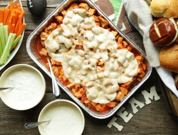 Buffalo chicken sliders in a disposable aluminum pan