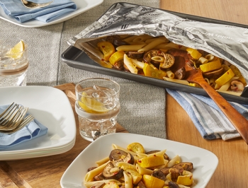 Lemony Pasta with Eggplant, Mushroom & Squash served on a white plate alongside an open Reynolds Grill Bag with additional servings